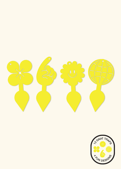 Four yellow sticky gnat traps with staked bottoms. From left to right, there is a flower shape, a pointing finger shape, a smiling sun shape, and a globe shape.