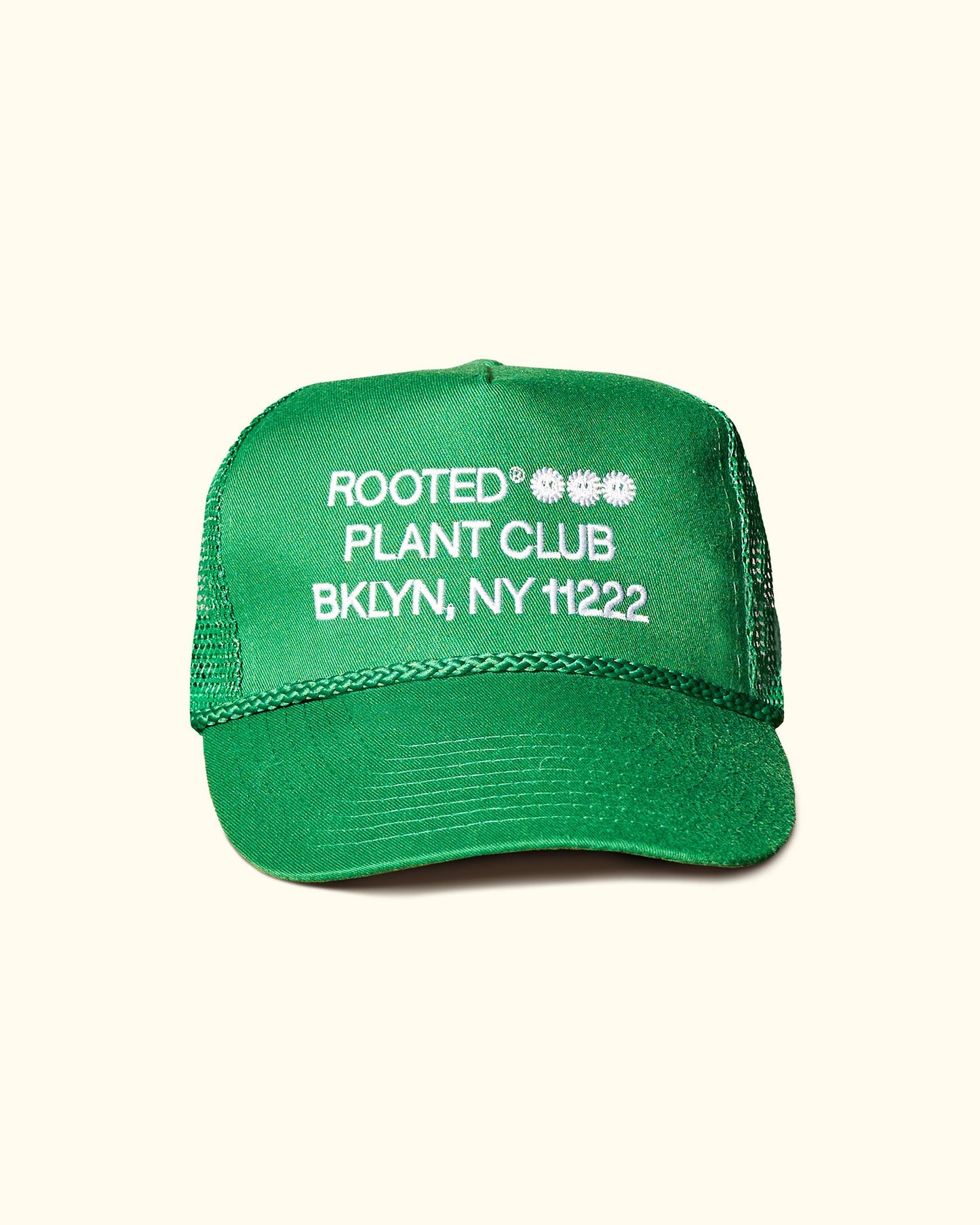 A green colored trucker hat that reads: Rooted Plant Club. BKLYN, NY 11222